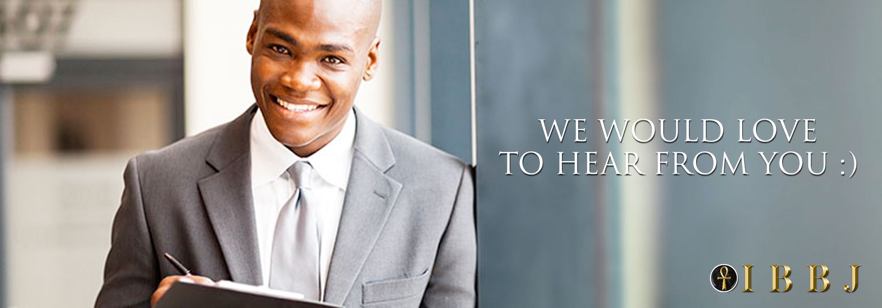 Smiling businessman holding a clipboard.